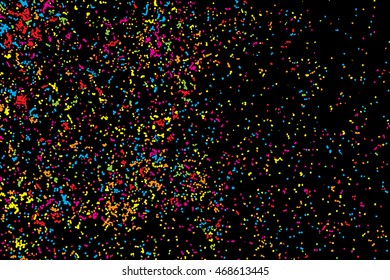Abstract background with many splattered falling round glitter pieces. Sprinkle random pattern, confetti blow. Colorful celebration background with confetti isolated on black, holiday illustration.