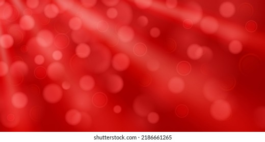 Abstrakter Hintergrund in roten Farben mit divergierenden Strahlen von Licht und kleinen durchsichtigen Kreisen mit Bokeh-Effekt