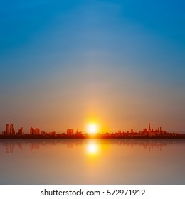 abstract background with spring sunset and silhouette of city