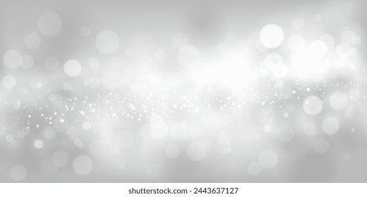 Abstract background in white and gray tones with many shiny sparkles, some of which are in focus and others are blurred, creating a captivating bokeh effect.