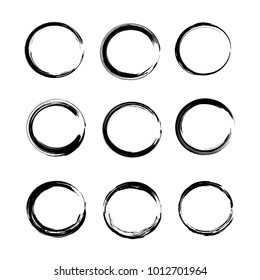 Abstract black hand-drawn brush circle strokes isolated on a white background