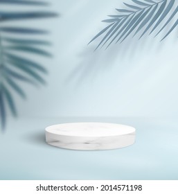 abstract blue background with empty marble pedestal and decorative palm trees.