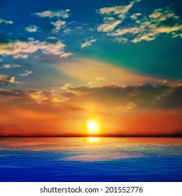 abstract blue nature background with sea red sunset and clouds