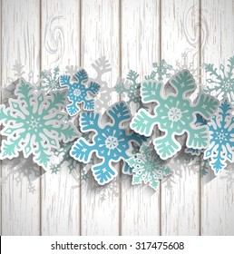 Abstract blue snowflakes  with 3d effect on white wooden background, winter or christmas concept, vector illustration, eps 10 with transparency