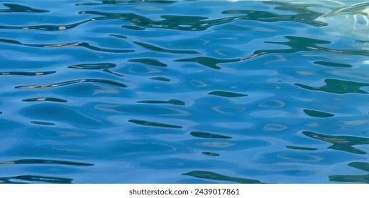 abstract Blue water surface with bright sun light reflections,summer background