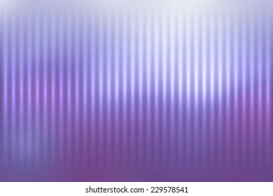 Abstract blur colored background with defocused vertical rays of light.