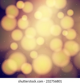 Abstract blur of dark chocolate background with bokeh lights and gold sparkles