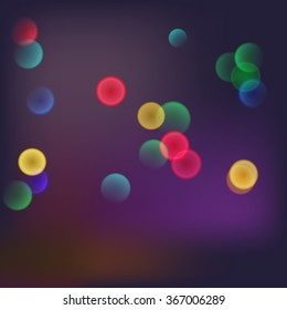 Abstract blurred background with bokeh effect and glowing colored spots. 