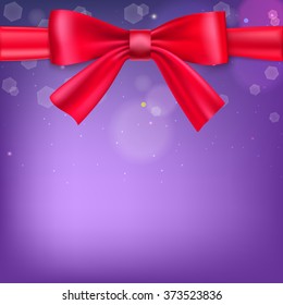 Abstract blurred background with bokeh effect and glowing colored spots. Tied with a big red bow