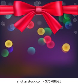 Abstract blurred background with bokeh effect and glowing colored spots. Tied with a big red bow