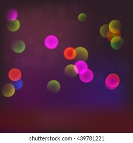 Abstract blurred background with bokeh effect and glowing colored spots.