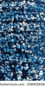 Abstract Bokeh Background: A stunning image featuring a blend of blue and white circular light patterns. Perfect for design projects, backgrounds, or artistic compositions.