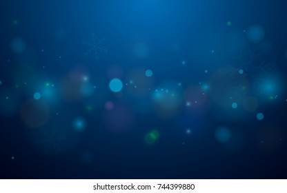 Abstract bokeh and snowflakes in blue background. Merry christmas concept