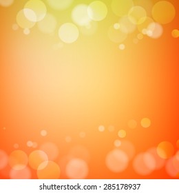 Abstract bokeh sparkles on orange blurred background