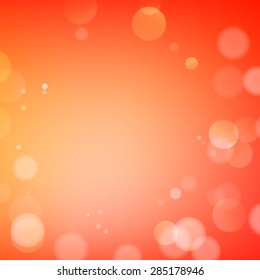 Abstract bokeh sparkles on orange blurred background