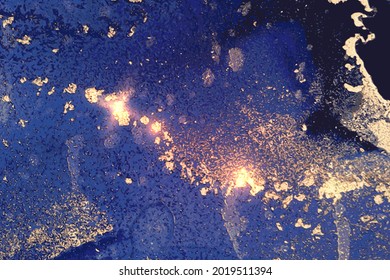 Abstract bright blue and gold background with marble texture and shining glitter. Vector stone surface in alcohol ink technique. Fluid art illustration for poster, flyer, brochure design.