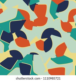 An abstract camouflage pattern containing uneven spots of different colors. Fashionable texture.