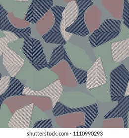 An abstract camouflage pattern containing uneven spots of different colors. Fashionable texture. Squares consisting of diagonal segments located in staggered order.