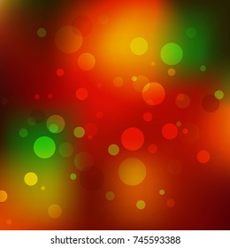 Abstract Christmas background. Red, orange and green holiday bokeh. Magic sparkling holiday abstract glitter background.