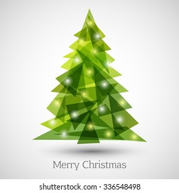 Abstract christmas tree made of green triangles. Christmas tree greeting card background