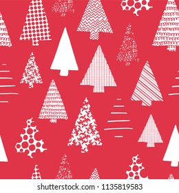 Abstract Christmas trees vector seamless pattern. White tree silhouettes on a red background. Modern Christmas design. Perfect for Christmas cards, gift wrap, fabric, and packaging.