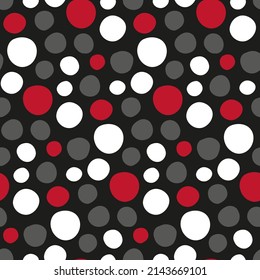 Abstract circles pattern for fabric jackets, covers. Handwritten speckled seamless texture. Polka dots freehand print. Red, black, white spots on black background for modern textiles. Rounded shapes.