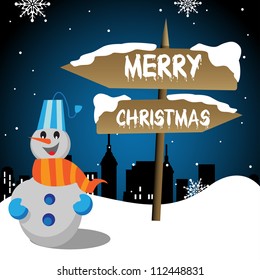 Abstract colorful background with a happy snowman standing in front of a wooden pointer on which is written the text Merry Christmas. Christmas theme