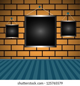 Abstract colorful background with three black empty frames hanging on a brick wall