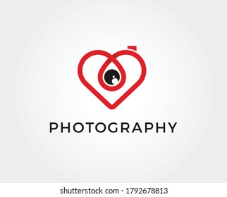 Abstract colorful photo camera with heart lens. Vector logo icon template. Design concept for wedding photographer. Love story photo symbol.