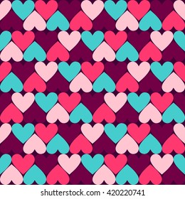 Abstract colorful seamless geometric pattern with hearts in ornamental background in vector. 