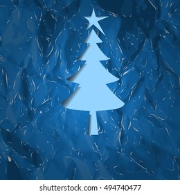 Abstract contour Christmas tree cut from blue  background.