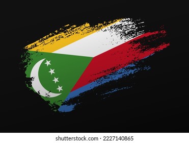 Abstract creative patriotic hand painted stain brush flag of Comoros on black background