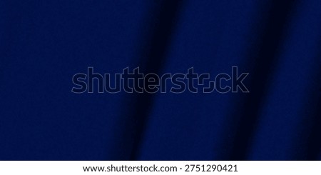 Abstract dark background. Silk satin fabric. Navy blue color. Elegant background with space for design. Soft wavy folds. Christmas, birthday, anniversary, award. Template.