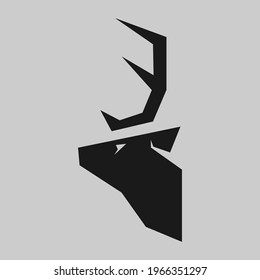 Abstract deer head silhouette in profile portrait symbol on gray backdrop. Design element