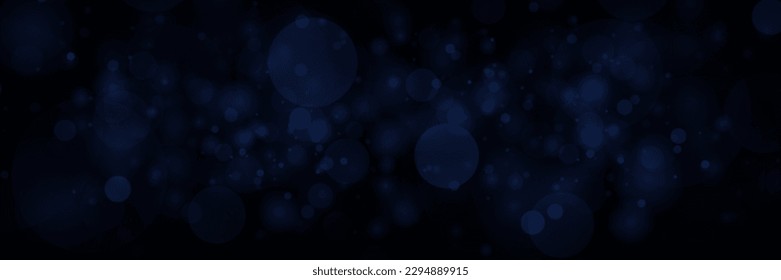 Abstract defocused circular blue bokeh on dark background. 