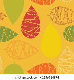 Abstract doodle leaves red green orange on a mustard yellow background. Seamless vector pattern. Perfect for fabric, all kinds of paper projects, and stationery, Thanksgiving, page fill, web banner