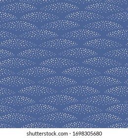 Abstract dot pattern design background in wave shapes. Vector seamless repeat of spots in navy blue and white.