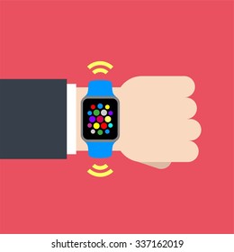 Abstract flat design vector illustration of a businessman hand with a smart watch with interface icons on a pink background