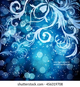 Abstract floral pattern on a blue background, made of transparent rays, stars, bokeh. Magical fantasy flowers design card.  