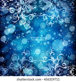 Abstract floral pattern on a blue background, made of transparent rays, stars, bokeh. Magical fantasy flowers design card.  