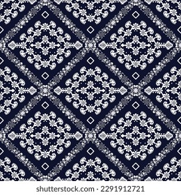 Abstract floral patterned turban. White on a navy blue background. Seamless pattern.