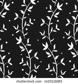 Abstract floral seamless pattern with white vertical branches and leaves on black background; floral design for fabric, wallpaper, textile, wrapping paper, web design.