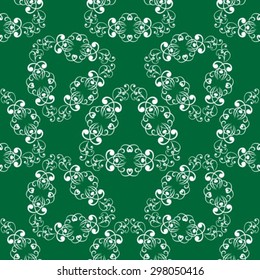 Abstract gentle seamless floral pattern on a green background.