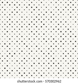 Abstract geometric background with irregular structure of repeating dots. Stylish halftone texture perfect for prints, wallpapers and ceramics. Vector seamless pattern.