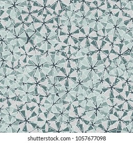 Abstract geometric flowers from triangles are randomly distributed. Seamless pattern.