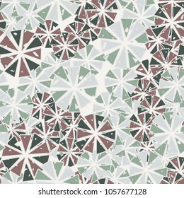 Abstract geometric flowers from triangles are randomly distributed. Seamless pattern.