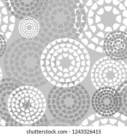 Abstract geometric pattern by the points, circles. Gray and white texture. A seamless vector background.