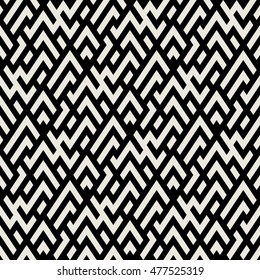 Abstract geometric pattern with maze, diagonal overlapping stripes and crossing lines in black and white. Op art seamless geometric background. Simple monochrome bold print for winter fall fashion