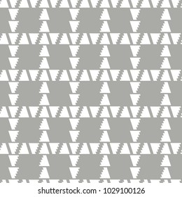 Abstract geometric plaid seamless vector pattern of white triangle with jagged edge on grey background