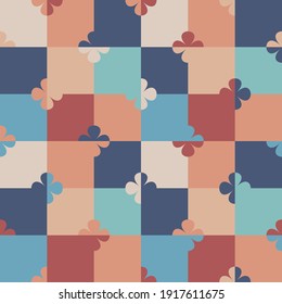 Abstract geometric seamless vector pattern with stylized flowers on a colourful chessboard in retro style. Decorative floral grid texture in vintage colour scheme for wallpaper and prints. 